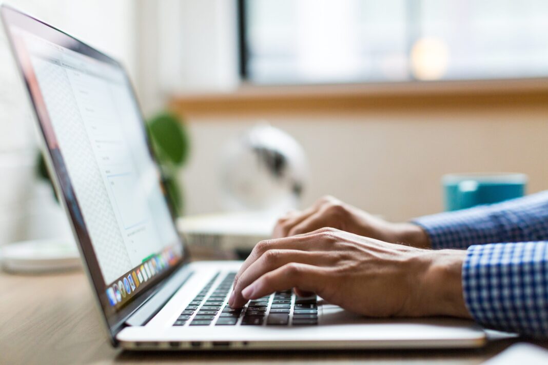 person-using-macbook-374720 man writing email