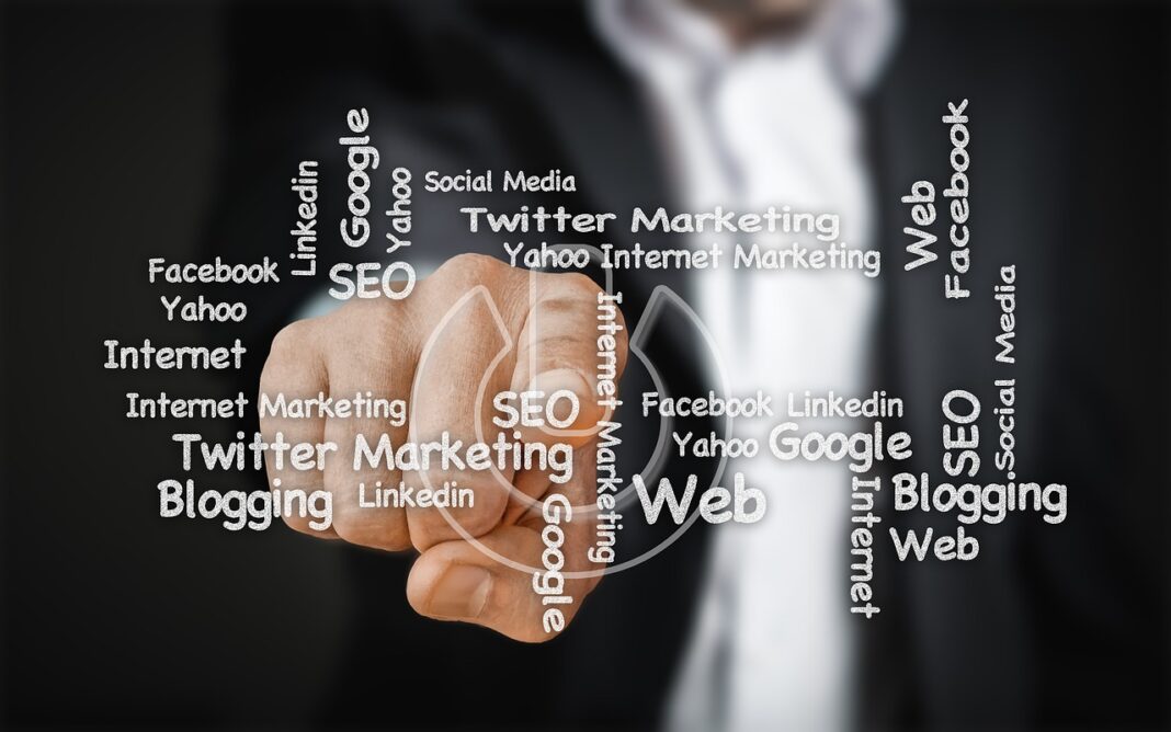 man-pointing-to-a-screen-with-terms-related-to-rem man pointing to a screen with terms related to remote SEO jobs