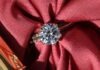 Why Diamonds Are a Status Symbol? silver diamond ring on red textile