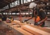How to Optimize Your Construction Site Safety Procedures man in orange and black vest wearing white helmet holding yellow and black power tool