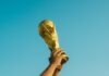 A Different Way to Build a Champion person holding gold trophy