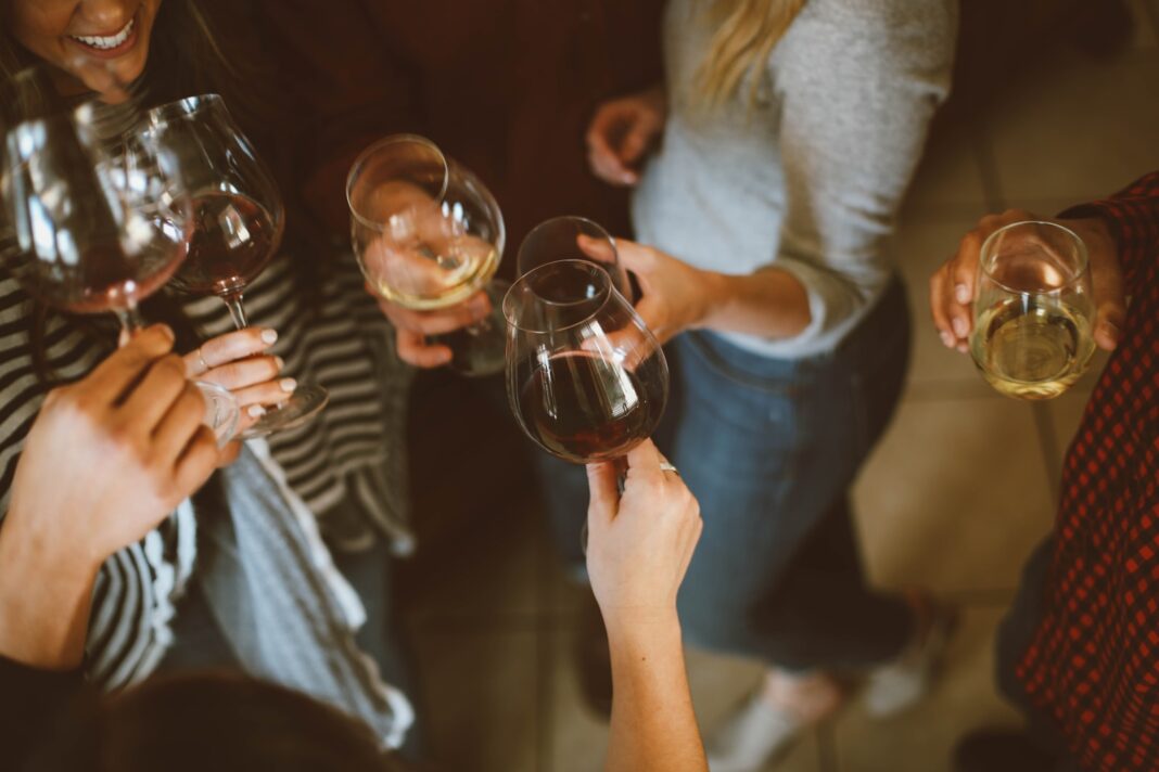 Photo by Kelsey Chance group of people tossing wine glass