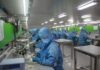 Can Bitcoin Affect the Electronic Manufacturing Industry man in blue jacket wearing blue mask