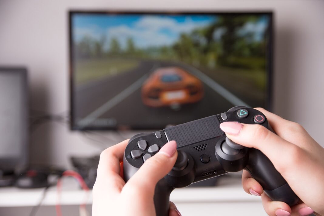 A person holding a video game controller Description automatically generated with low confidence