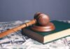 Cost to defend a business lawsuit in orange county, CA brown wooden chess piece on brown book