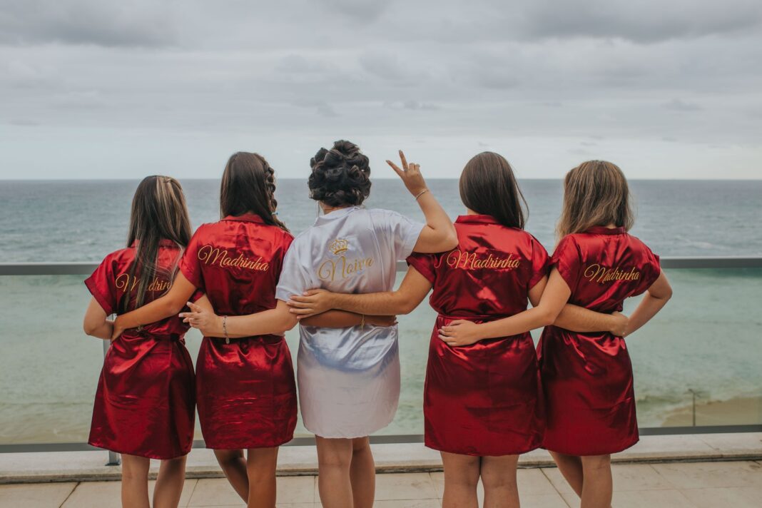 Photo by Fernanda Nuso brides and bridesmaid looking at the back