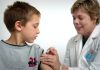 Do Children Need Health Insurance? woman inject boy on arm