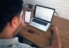 How does compounding work in investing? person holding iphone 6 near macbook pro