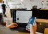 What is Remote Selling in Business? person using phone and laptop