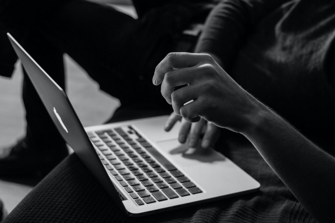 Photo by Sergey Zolkin grayscale photo of person using MacBook