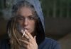 New Trends in Tobacco Smoking in Saudi Arabia woman wearing hoodie while holding cigarette