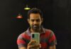 Eat-and-Run Verification Step man in red and gray striped crew neck t-shirt holding gold iphone 6