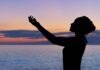 What is Reiki Healing? – A dismantling of the don’ts and enjoying the experiences! silhouette of woman raising her right hand