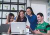 Live Dealer Games: How It Works, Opportunities and Benefits for The Player four people watching on white MacBook on top of glass-top table