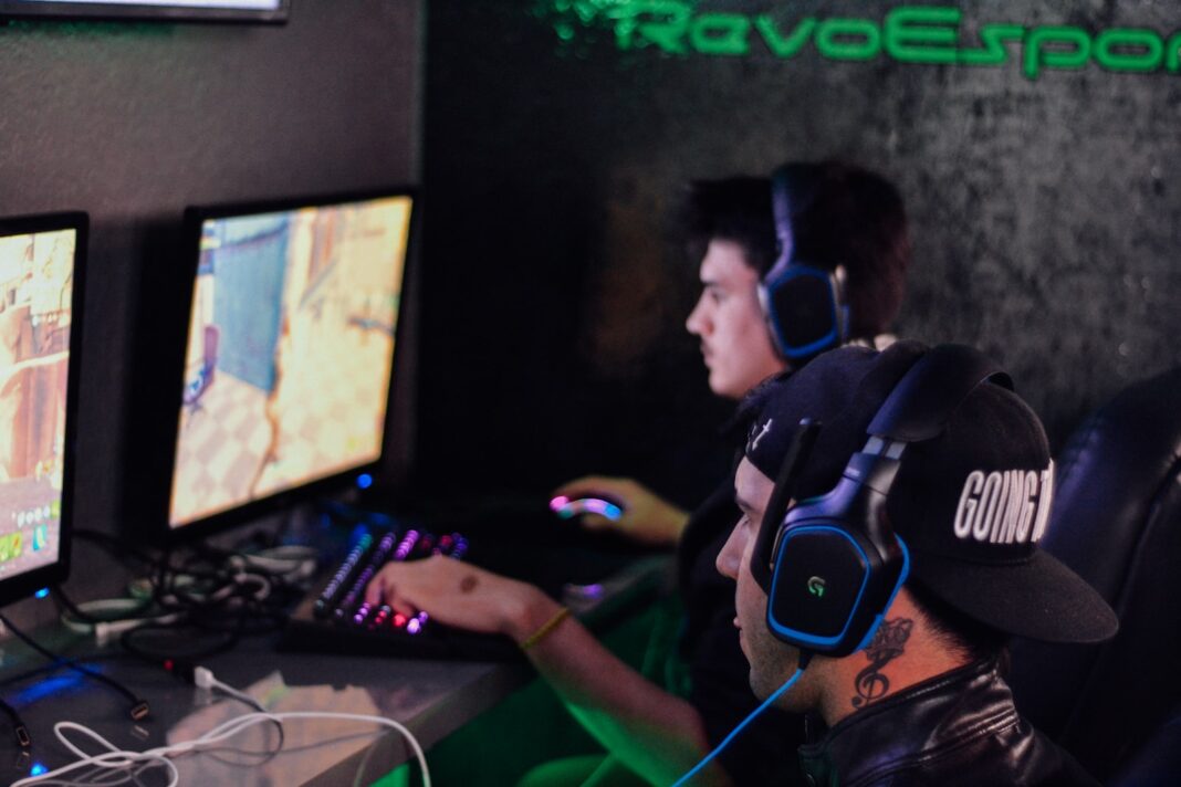 Photo by Alex Haney two men playing PC games