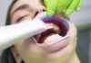 Top 5 Traits You Should Look For in a Biological Dentist boy with green and white pacifier
