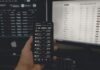 EOS Crypto Price Prediction person holding black android smartphone