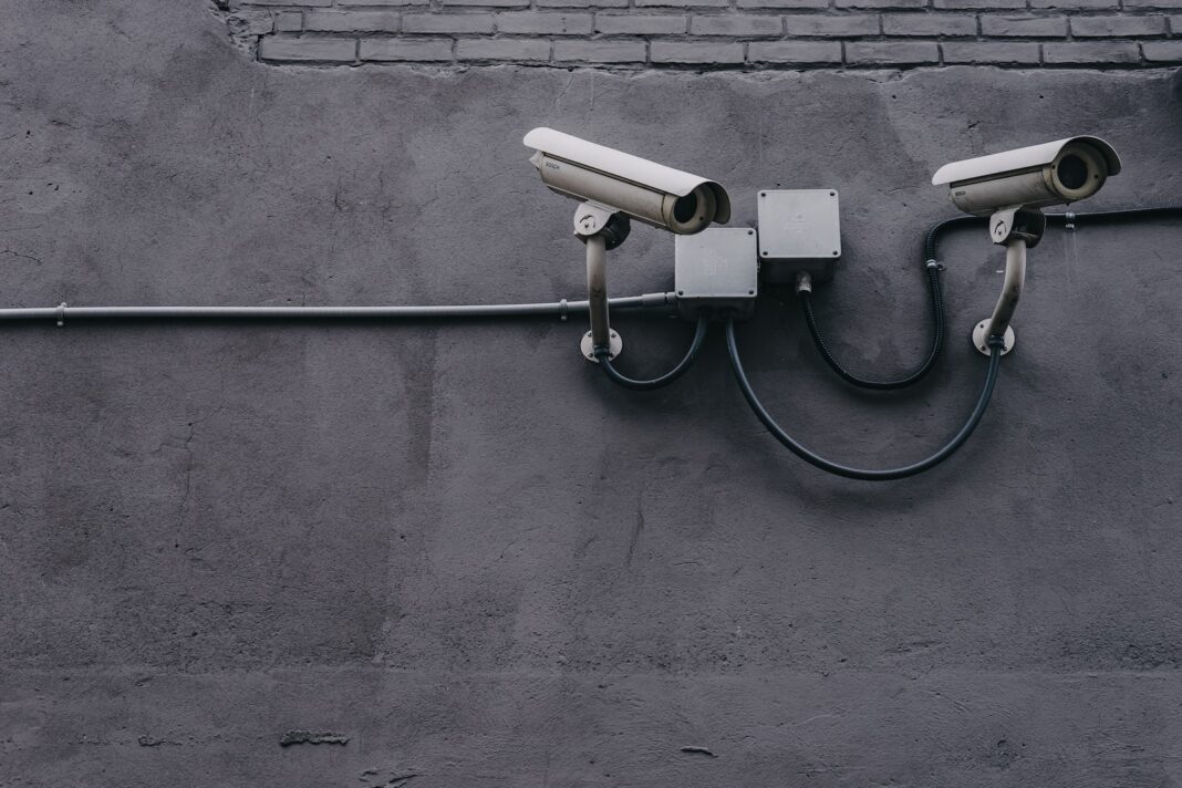 Photo by Scott Webb two bullet surveillance cameras attached on wall