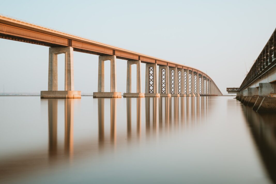 Photo by Chris Briggs brown wooden bridge over body of water