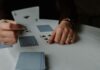 The Best Beginner Friendly Casino Games person holding playing cards on white table