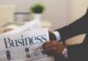How to Create A Finance Tech Stack Fit For Your Business person wearing suit reading business newspaper