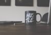 A Guide to Getting Your Business Up and Running black and white Hustle-printed ceramic mug on table