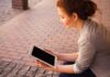 The List of the Most Popular Online Casinos in AU woman holding white iPad