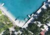 PLANNING A TRIP TO THE MALDIVES? HERE IS HOW TO CHOOSE THE RIGHT RESORT aerial photography of boats docked near shore