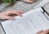 Is Wawanesa a Good Insurance Company? Person Holding Home Insurance Form