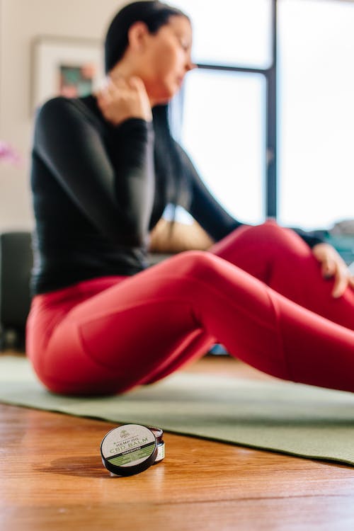 Free Woman Sitting on Yoga Mat Stock Photo