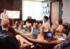 5 Different Management Styles for Effective Leadership man standing in front of people sitting beside table with laptop computers