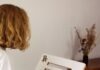 What Jobs Will AI Drawing Tools Replace? a young girl is working on a model of a house