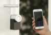 Keyless Entry Systems for Businesses: Advantages and Features gold Apple iPhone smartphone held at the door