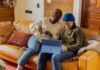 Why Speed Matters Online? a person sitting on a couch with a laptop