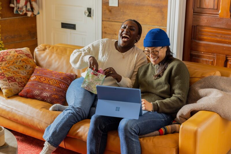 Photo by Surface a person sitting on a couch with a laptop