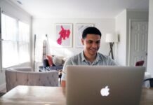 Unlocking the Digital Market: 5 Lucrative Ways to Make Money Online in the US man in gray hoodie sitting on chair in front of silver macbook