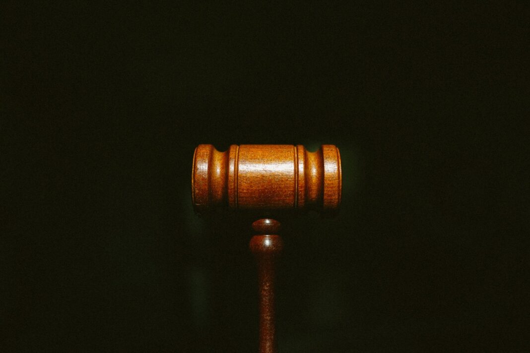 Photo by Tingey Injury Law Firm brown wooden stand with black background