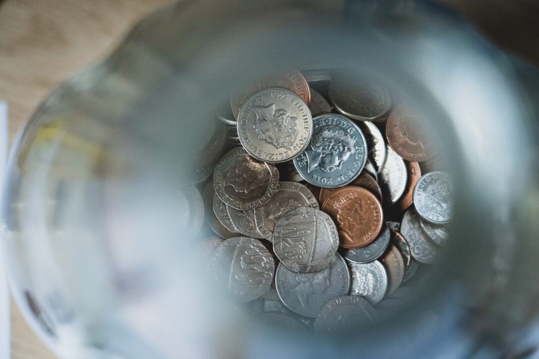 Photo by Nick Fewings silver round coins on blue round container