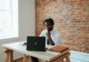 Finance and accounting outsourcing for SMBs a man sitting at a table in front of a laptop