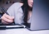 How to assess your solvency before taking a loan? woman using drawing pad while sitting in front of laptop