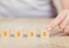Loans vs. Lines of Credit – Which One Works for You? Photo woman hand arranging wood block with icon money dollar growth finance and investment concept.