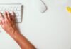 Elevate Your Brand: The Impact of Working with Guest Post Agencies person typing on Apple Cordless Keyboard