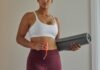 Emsella: Strengthen Your Pelvic Floor Muscles and Treatment For Incontinence woman in white sports bra and purple leggings holding black speaker