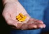 Unmasking the World of Health Supplements: A Comprehensive Guide yellow medication pill on persons hand