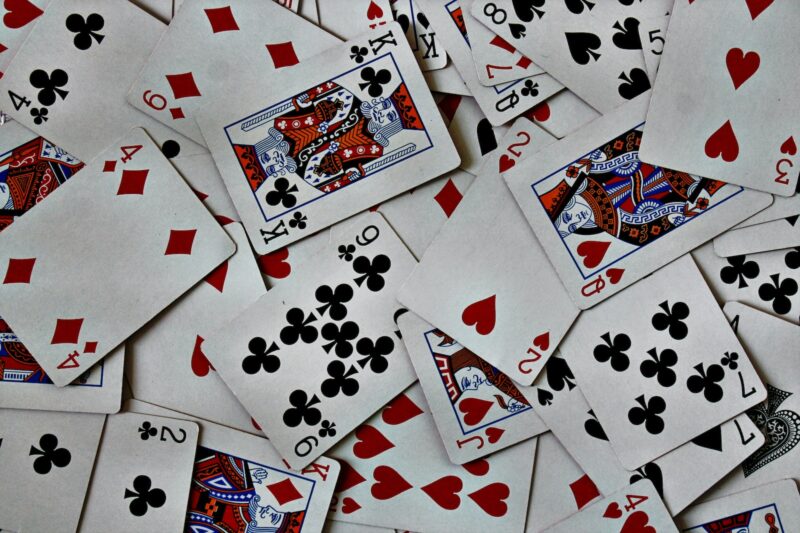 Photo by Amanda Jones a pile of playing cards sitting on top of each other