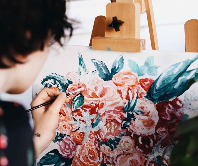 Photo by tabitha turner woman in red and white floral dress painting