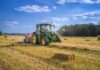 The Essential Advantages of Having a Tractor on Your Farm green tractor on brown grass field under blue sky during daytime