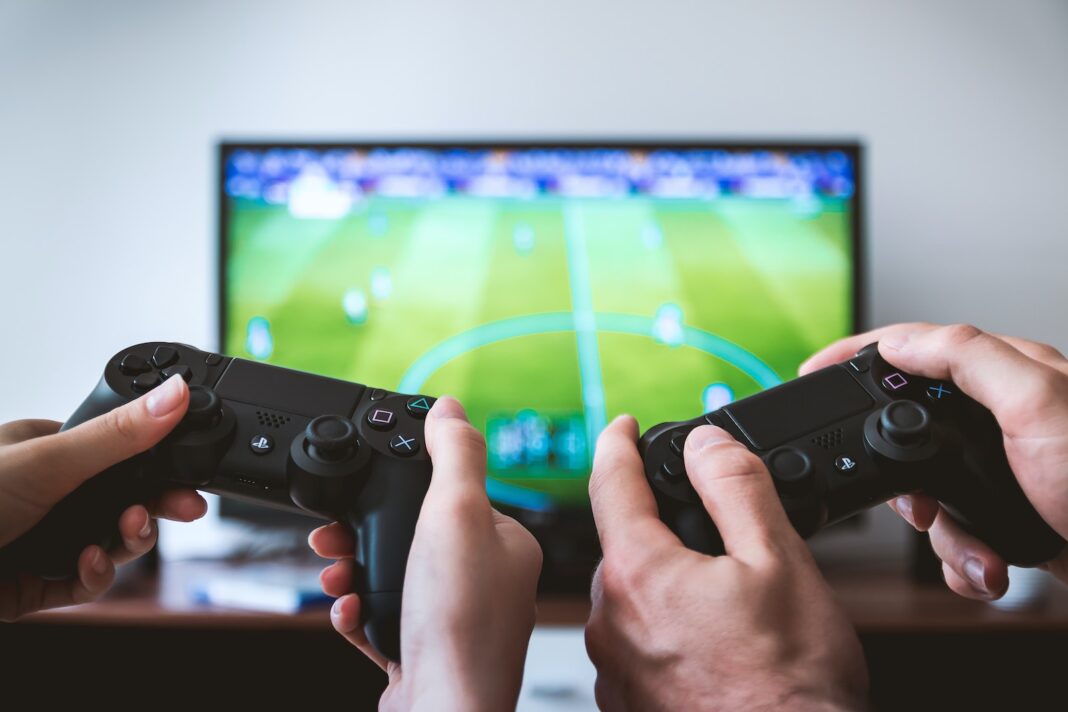 Photo by JESHOOTS.COM two people playing Sony PS4 game console