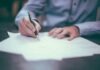 Myths About Cheap Consumer Loans or Billige Forbrukslån man writing on paper
