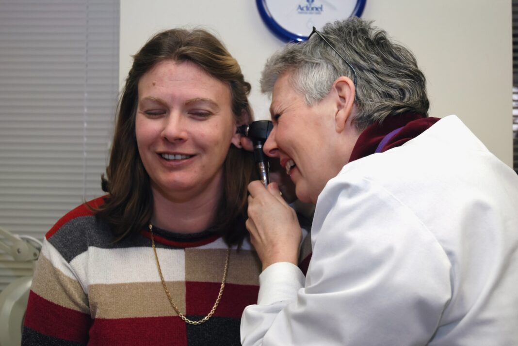 Photo by National Cancer Institute a woman talking on a cell phone next to a man
